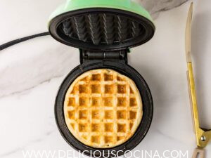 A cooked waffle in a waffle maker